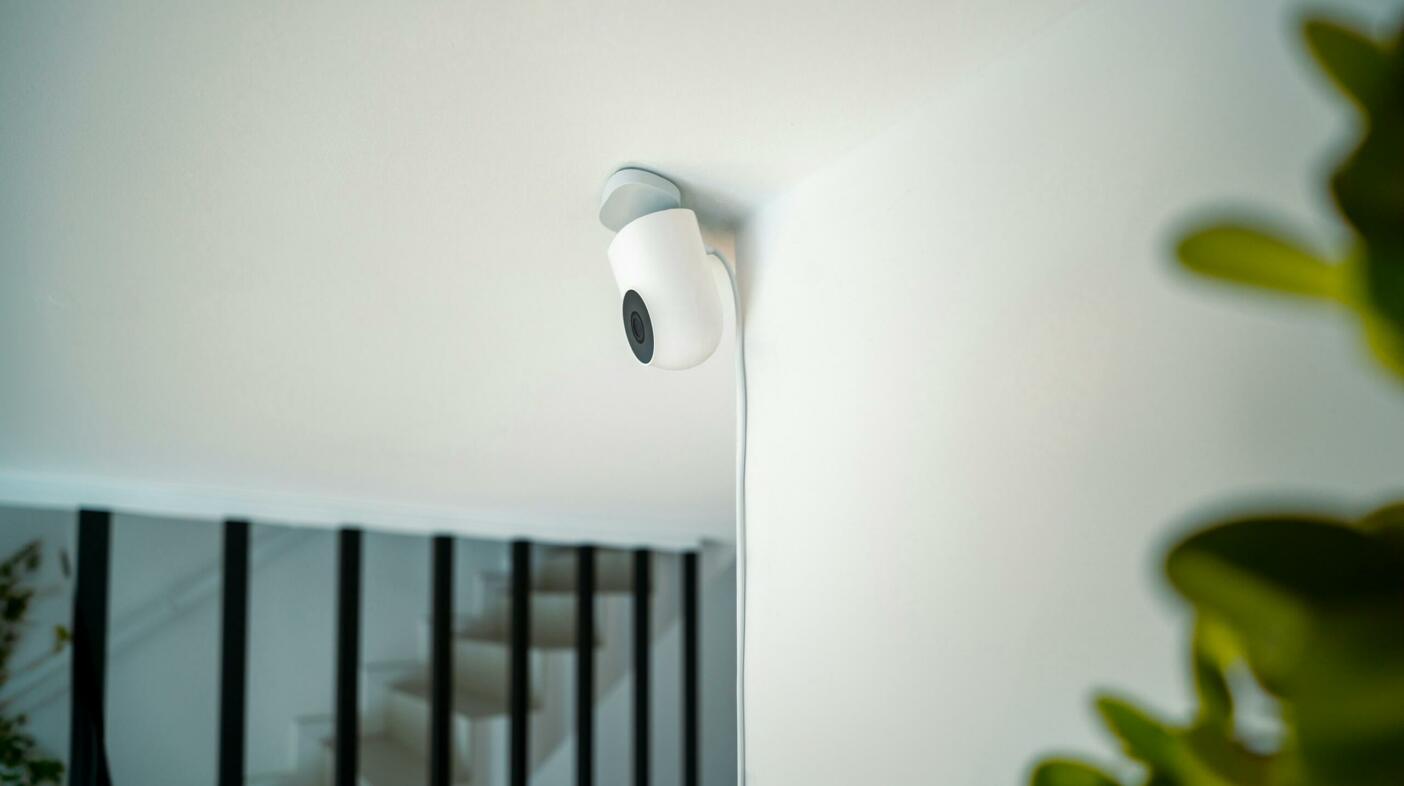 Photograph of a security camera mounted on a ceiling